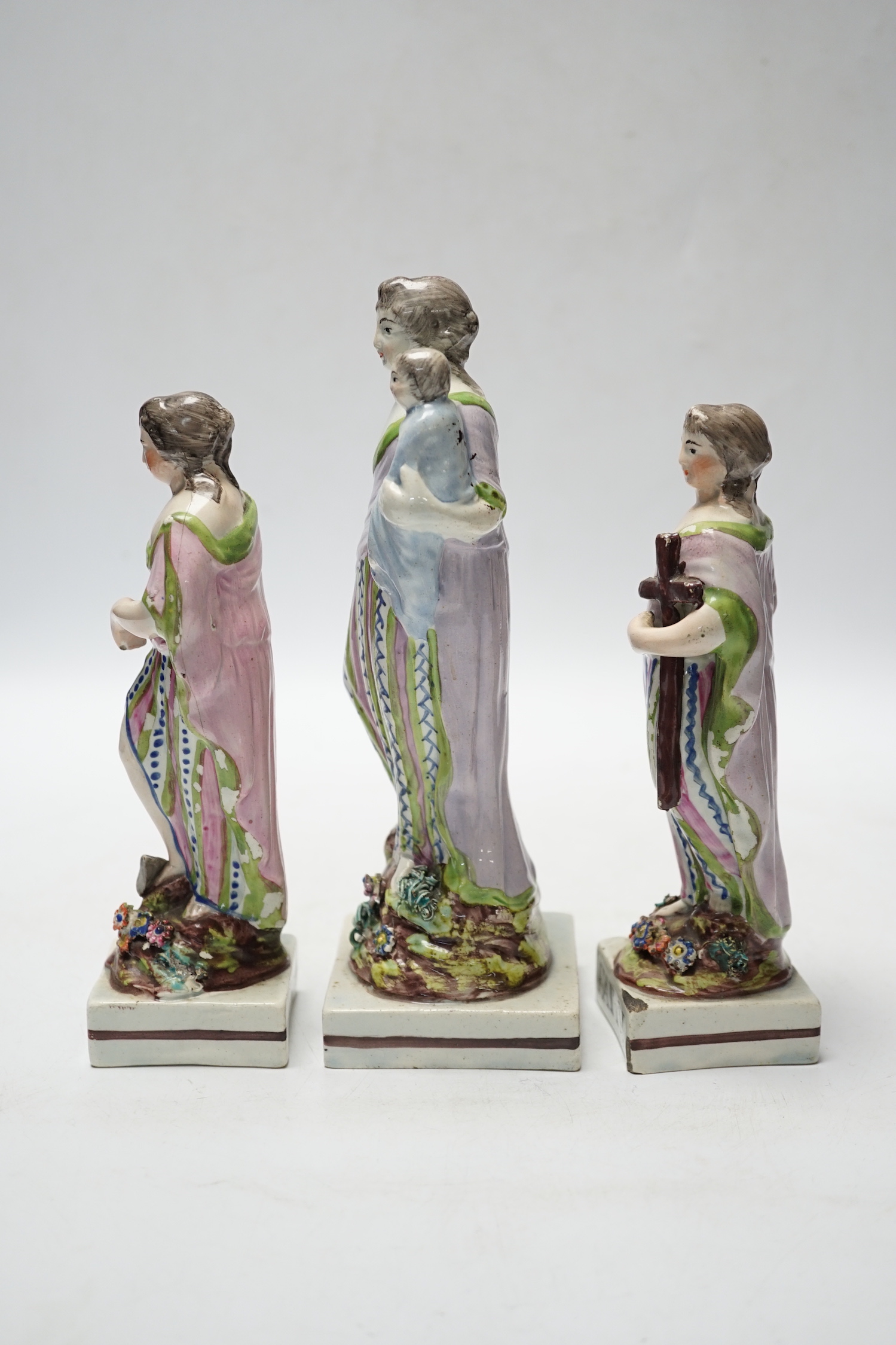 A set of three pearlware figures of Faith, Hope and Charity, c.1810, largest 21cm high